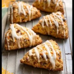 Delicious carrot cake scones with cream cheese glaze on a plate