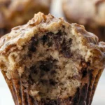 Freshly baked Nutella Banana Muffins with chocolate drizzle on top