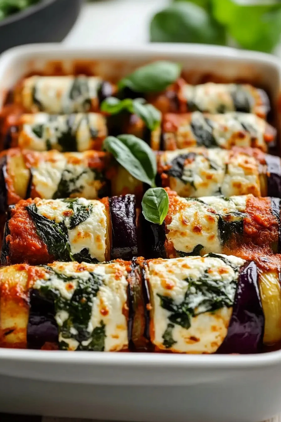 Savory eggplant roll-ups stuffed with ricotta and spinach on a plate