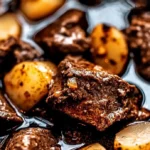Slow Cooker Garlic Butter Beef Bites served with potatoes for a tasty meal