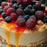 Summer berry peach cheesecake topped with fresh berries and peaches