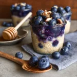 Blueberry overnight quinoa topped with fresh blueberries and nuts in a bowl.