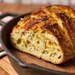 Freshly baked Italian Herb and Cheese Sourdough Bread with a golden crust
