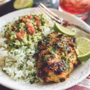 Plate of Chicken with Cilantro Lime Rice garnished with fresh cilantro.
