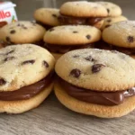 Nutella filled chocolate chip cookie sandwiches on a plate