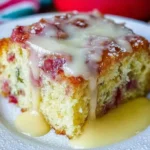 Slice of Rhubarb Cake with Butter Sauce on a white plate