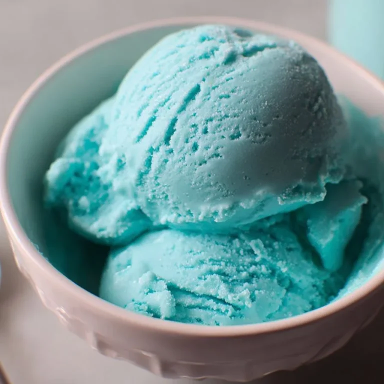 A scoop of Blue Moon Ice Cream in a cone with a vibrant blue color.