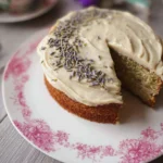 Sliced Earl Grey Tea Cake with Lavender Buttercream frosting on a white plate.