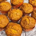 Freshly baked easy pumpkin muffins topped with spices and served warm.