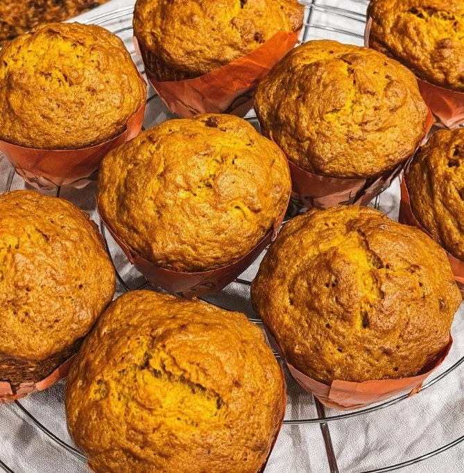 Freshly baked easy pumpkin muffins topped with spices and served warm.