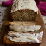 Delicious Lavender Banana Bread topped with creamy icing on a wooden table