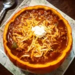 Bowl of hearty pumpkin chili topped with herbs and spices