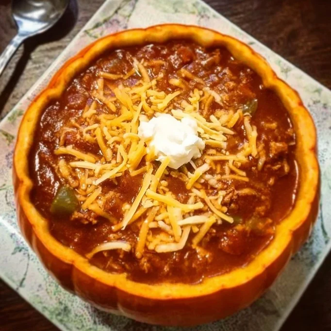 Bowl of hearty pumpkin chili topped with herbs and spices