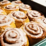 Freshly baked Pumpkin Cinnamon Rolls with cream cheese icing