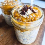 Delicious bowl of Pumpkin Overnight Oats topped with nuts and spices