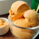 Creamy sweet potato pie ice cream served in a bowl with a spoon