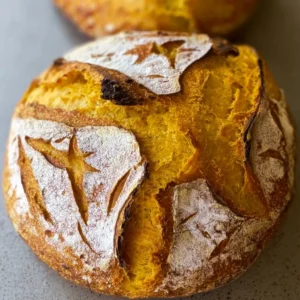 Freshly baked Pumpkin Sourdough Loaf with a golden crust and autumn spices
