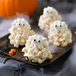 Spooky Halloween popcorn balls decorated for Halloween festivities.