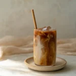 Delicious Caramel Iced Coffee served in a glass with whipped cream and caramel drizzle.