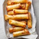 Delicious crispy cheese rolls served on a plate with golden, melty cheese inside.