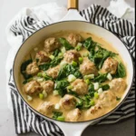 Healthy turkey Swedish meatballs served on a plate with gravy and herbs