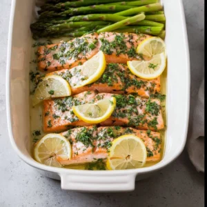 Delicious roasted salmon fillet cooked in butter, garnished with herbs.