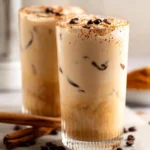 Cup of Vanilla Cinnamon Milk Tea with cinnamon sticks and vanilla beans