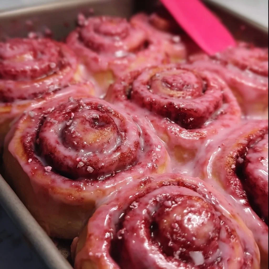 Pink Velvet Cinnamon Rolls topped with cream cheese frosting