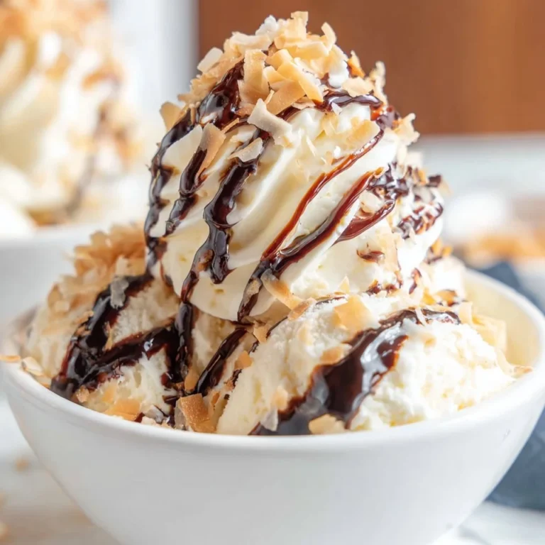 Samoa Ice Cream in a bowl topped with coconut flakes and caramel drizzle