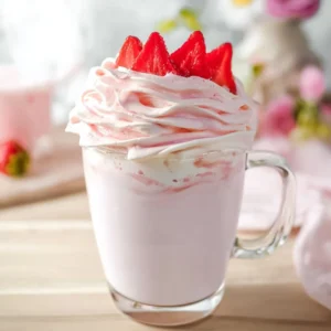 Delicious strawberry whipped milk served in a glass with fresh strawberries