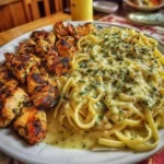 Garlic Butter Chicken served with Velvety Parmesan Linguine on a plate