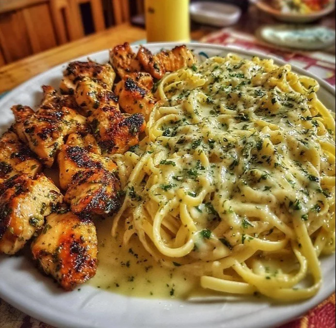 Garlic Butter Chicken served with Velvety Parmesan Linguine on a plate