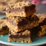 Delicious no-bake chocolate peanut butter oat bars on a wooden table