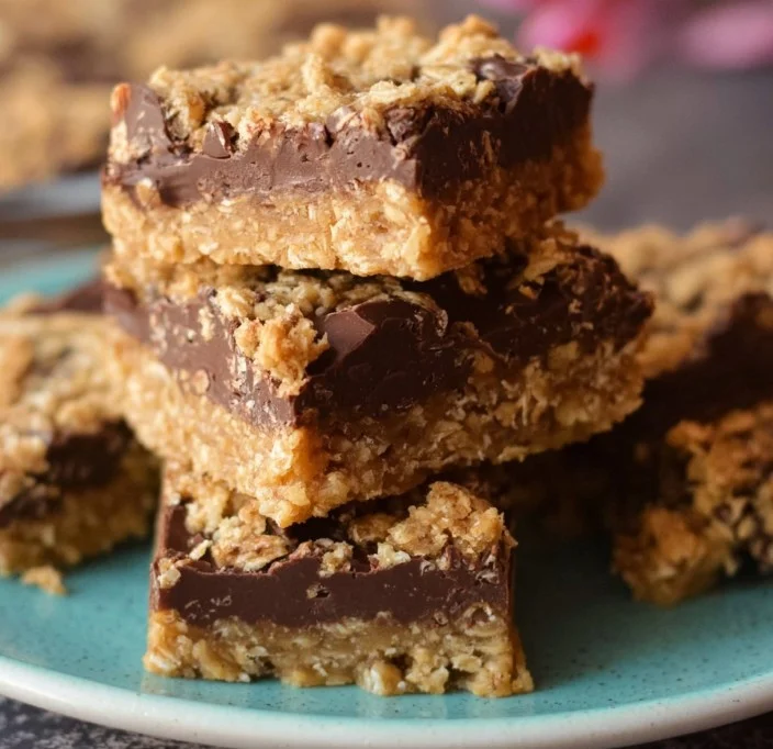 Delicious no-bake chocolate peanut butter oat bars on a wooden table