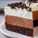 Decadent Oreo Mousse Cake topped with crushed Oreos and whipped cream