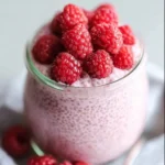 Delicious Raspberry Chia Pudding topped with fresh raspberries and maple syrup.