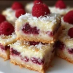 Delicious Raspberry Coconut Bars topped with fresh raspberries and coconut flakes.