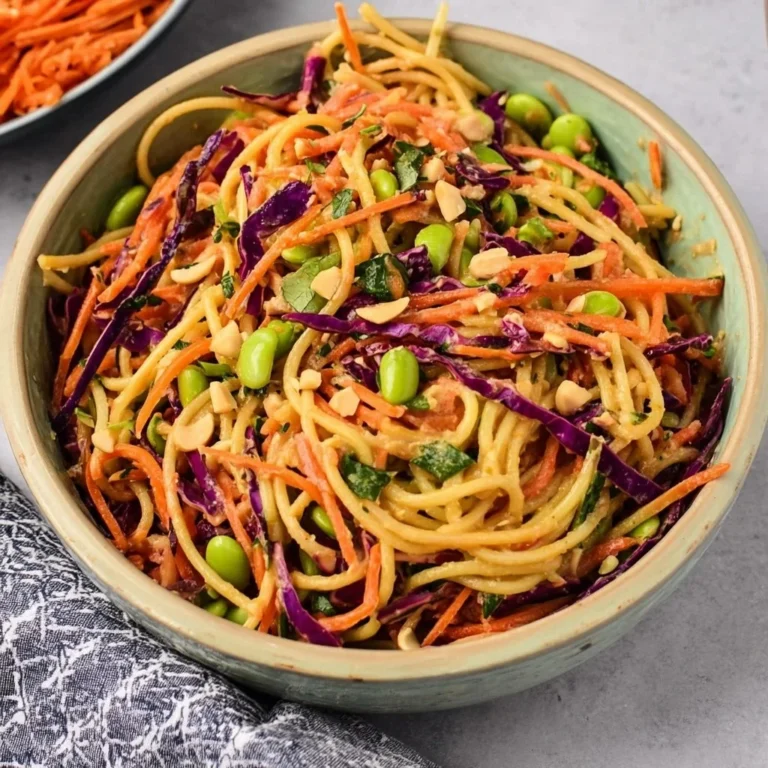 Colorful bowl of Thai Peanut Pasta Salad with vegetables and peanuts