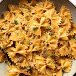 Vegan Marry Me Pasta served in a bowl with fresh basil and cherry tomatoes.