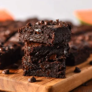 Delicious banana carrot brownies topped with nuts and chocolate drizzle