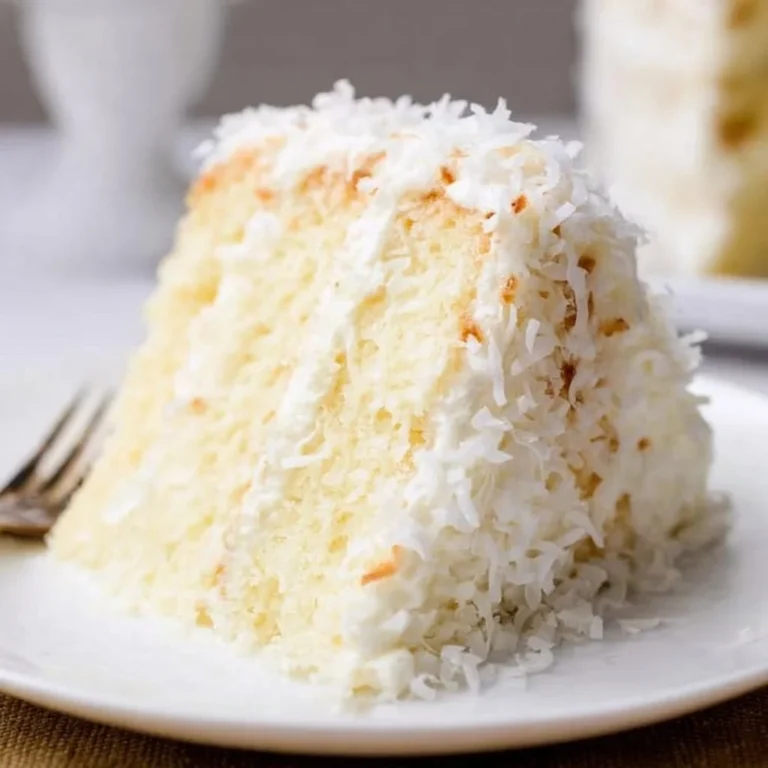 Delicious coconut cake with cream cheese frosting on a decorative plate