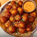 Deliciously crispy potato balls served on a plate, perfect for snacking.