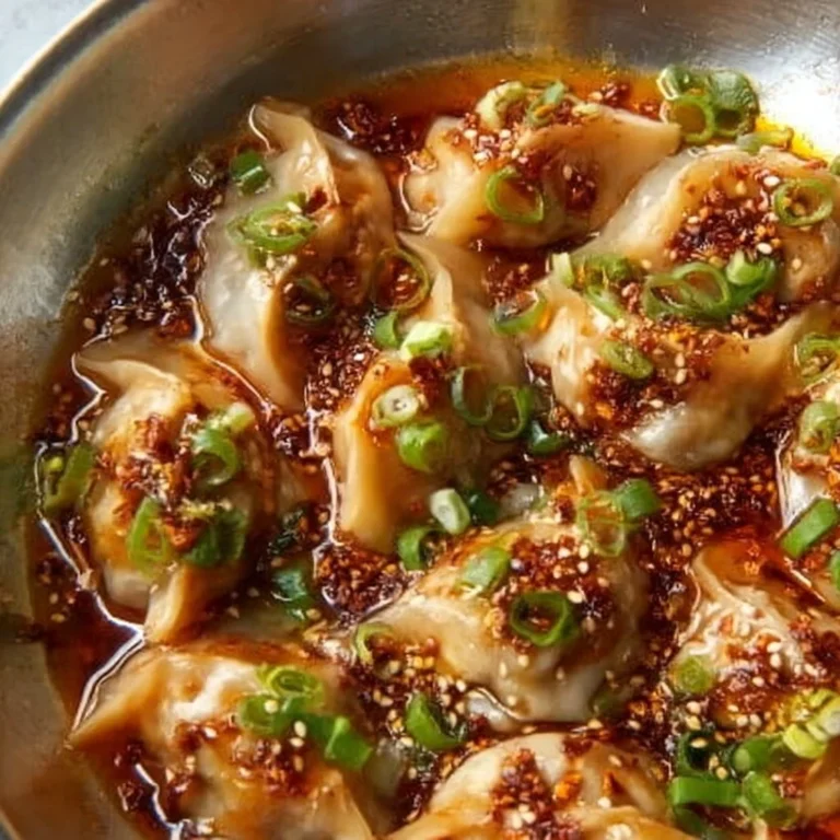 Plate of lazy vegan dumplings with chili crisp drizzled on top.