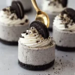 No-bake Oreo cheesecakes topped with crushed Oreos and whipped cream