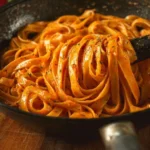 Delicious Roasted Tomato Garlic Butter Pasta garnished with fresh herbs.